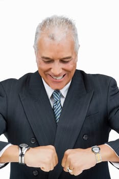 Close-up of a businessman looking at his wristwatches