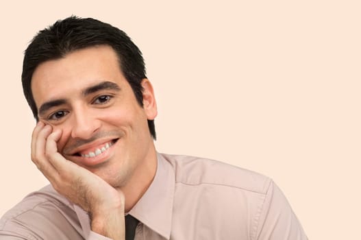 Portrait of a businessman smiling with his hand on his chin