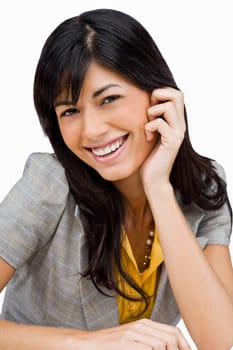 Portrait of a young woman smiling with her hand on her chin