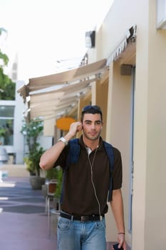 Portrait of a young man listening to an MP3 player