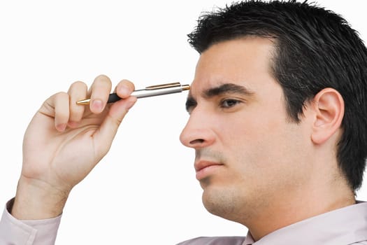 Close-up of a businessman holding a pen and thinking