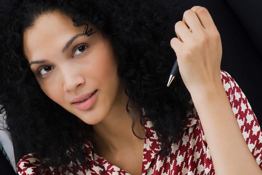 Close-up of a businesswoman holding a pen