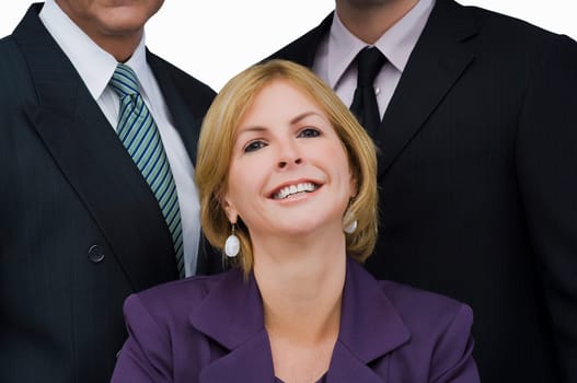 Portrait of a businesswoman smiling with two businessmen behind her