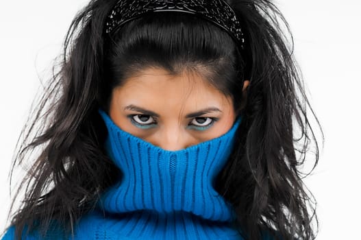 Portrait of a young woman hiding her face in her dress