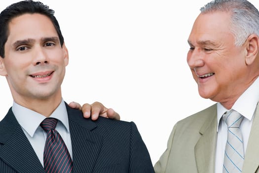 Close-up of a businessman putting his hand on another businessman's shoulders