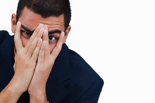 Portrait of a businessman covering his face with his hands