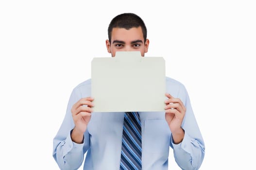 Portrait of a businessman holding a placard in front of his face