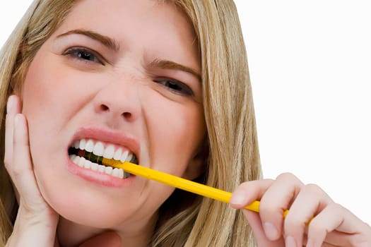 Portrait of a young woman biting a pencil