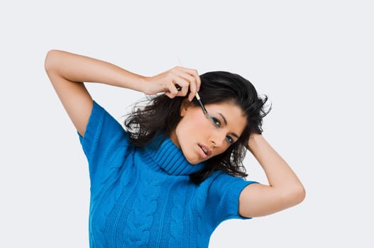 Portrait of a young woman applying eye shadow