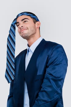 Close-up of a businessman wearing a tie on his head