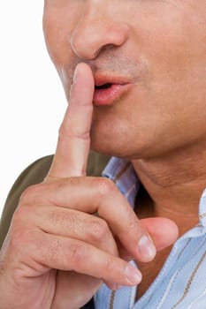 Close-up of a mature man with his finger on his lips