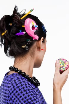 Close-up of office supply items in a young woman's hair