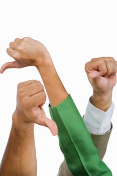 Close-up of business executives showing thumbs down sign