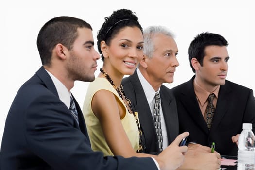Three businessmen and a businesswoman at a meeting in a conference room