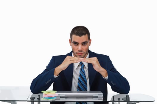 Portrait of a businessman sitting at a desk and gesturing