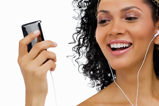 Close-up of a young woman listening to an MP3 player