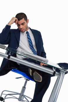 Businessman sitting at a desk and sleeping in an office