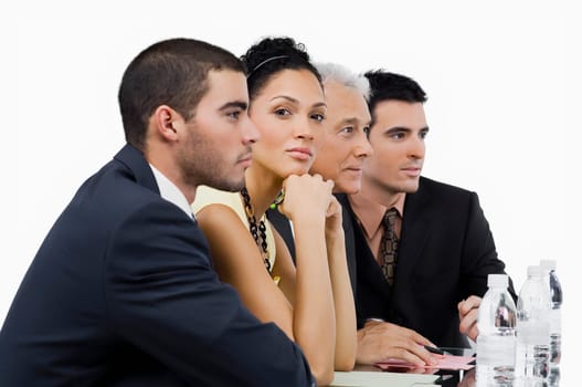 Three businessmen and a businesswoman at a meeting in a conference room