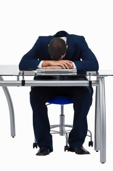 Businessman resting his head on a laptop