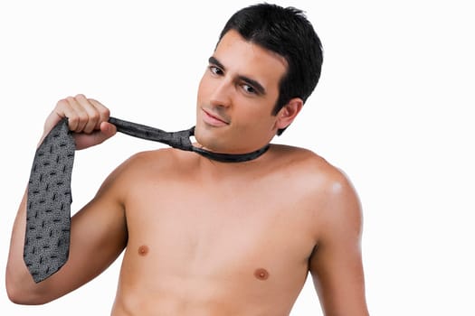 Portrait of a businessman pulling his tie
