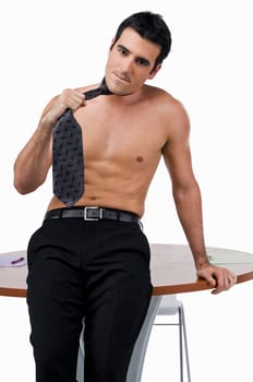 Portrait of a businessman leaning against a table