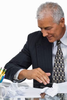 Close-up of a businessman sitting at a desk in an office