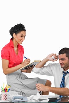 Businessman throwing a paper ball beside a businesswoman