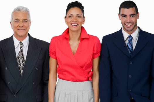 Portrait of a businesswoman standing with two businessmen and smiling