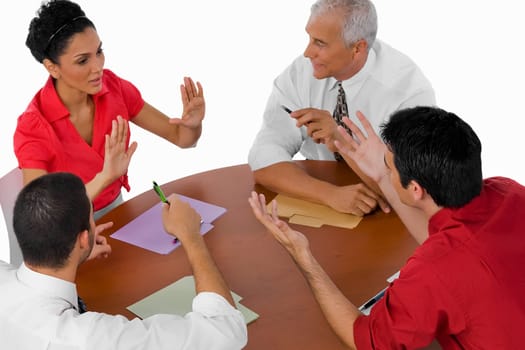 High angle view of three businessmen and a businesswoman discussing in a meeting
