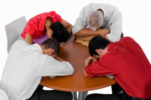 High angle view of three businessmen and a businesswoman resting their heads on a table