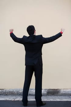 Businessman standing with his arm outstretched