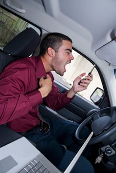 Side profile of a businessman sitting in a car and shouting