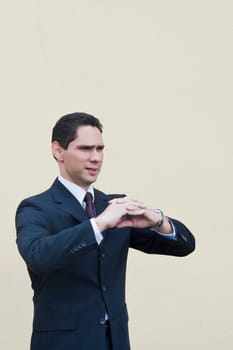 Businessman standing with his hands clasped