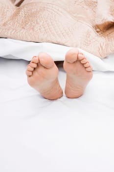 Close-up of a woman's feet on the bed