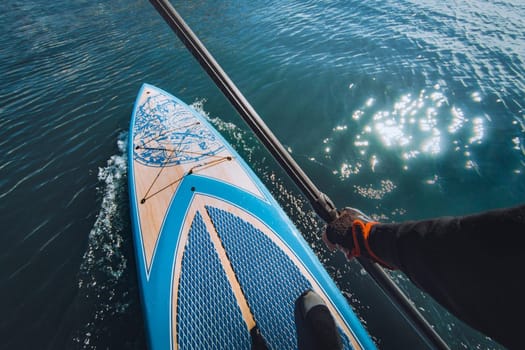 Sapboard with paddle on the water. One sport of sapboarding.