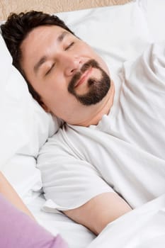 Mid adult man sleeping on the bed