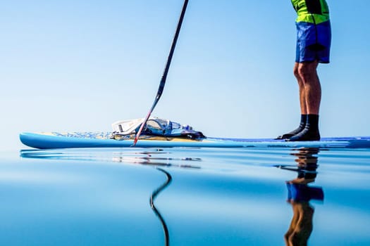 Sapboard with paddle on the water. One sport of sapboarding.