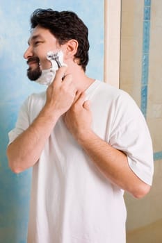 Mid adult man shaving in the bathroom