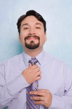Portrait of a businessman adjusting his tie