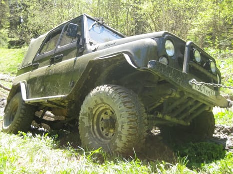 Moscow, Russia - June 23, 2019: It's a very dirty car. The SUV is driving through the mud.