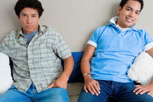 Two young men sitting on a couch
