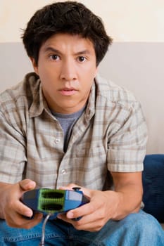 Close-up of a young man playing video game