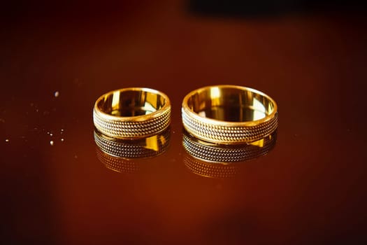 Two wedding rings on a red background. Wedding rings
