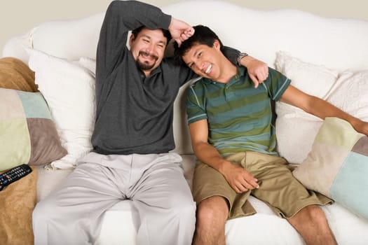 Mid adult man with his arm around his son