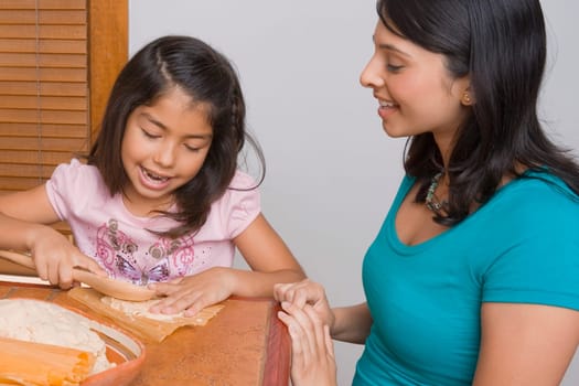 Girl preparing bread with her sister in the kitchen