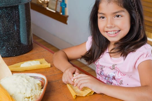 Close-up of a girl preparing bread