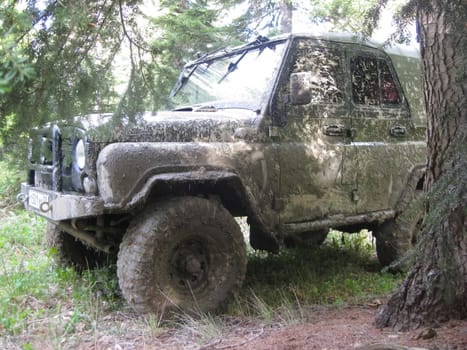 Moscow, Russia - June 23, 2019: It's a very dirty car. The SUV is driving through the mud.