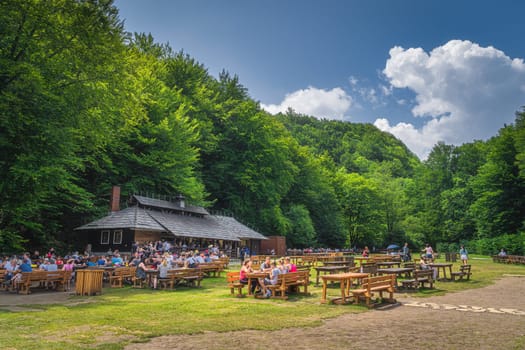 Plitvicka Jezera, Croatia, July 2019 Tourists relaxing and eating in wooden, open air restaurant, Plitvice Lakes National Park UNESCO World Heritage