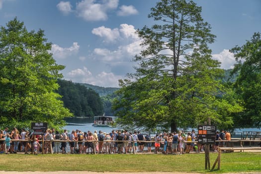 Plitvicka Jezera, Croatia, July 2019 Big crowd and queue of tourists for ferry to cross the lake in Plitvice Lakes National Park UNESCO World Heritage