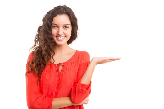 Young beautiful woman presenting your product, isolated over white background